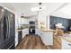 Modern kitchen with white cabinets, butcher block countertops, and a large island at 3407 W Arkansas Ave, Denver, CO 80219