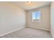 Bedroom with neutral walls, carpet, a window overlooking neighborhood at 798 Sawdust Dr, Brighton, CO 80601