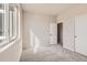 Bright bedroom features a large window and neutral carpeting at 798 Sawdust Dr, Brighton, CO 80601