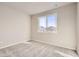 This carpeted bedroom has a large window with neighborhood views at 798 Sawdust Dr, Brighton, CO 80601