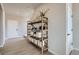 Stylishly decorated entryway with light wood floors and a wooden shelf holding decorative items at 798 Sawdust Dr, Brighton, CO 80601