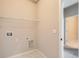Well-lit laundry room with washer/dryer hookups and ample shelving at 798 Sawdust Dr, Brighton, CO 80601