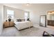 Spacious main bedroom with neutral tones, soft carpet, two windows, and a walk-in closet at 798 Sawdust Dr, Brighton, CO 80601
