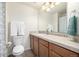This bathroom features a wooden vanity, ample lighting, and neutral wall color, creating a functional and calming space at 3578 Tranquility Trl, Castle Rock, CO 80109