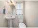 Clean bathroom featuring a pedestal sink, oval mirror, and natural light from a window at 3578 Tranquility Trl, Castle Rock, CO 80109