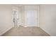 Bright bedroom with neutral carpet, closet with sliding doors, and an open doorway at 3578 Tranquility Trl, Castle Rock, CO 80109