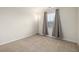 Bedroom featuring neutral carpet, a window with blinds and curtains, and ample natural light at 3578 Tranquility Trl, Castle Rock, CO 80109