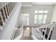 Open entryway with staircase, featuring a bright foyer and a view of the living room at 3578 Tranquility Trl, Castle Rock, CO 80109