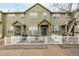 Charming townhome with green siding, white picket fence and inviting blue front door at 3578 Tranquility Trl, Castle Rock, CO 80109