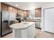 Spacious kitchen equipped with stainless steel appliances, an island, and oak cabinets at 3578 Tranquility Trl, Castle Rock, CO 80109