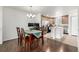 Open-concept dining area and kitchen with stainless appliances and island with bar seating at 3578 Tranquility Trl, Castle Rock, CO 80109