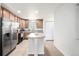 Well-lit kitchen featuring an island, stainless steel appliances and beautiful tile flooring at 3578 Tranquility Trl, Castle Rock, CO 80109