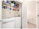 Laundry room featuring a washer, dryer, shelves, and an adjacent bathroom at 3578 Tranquility Trl, Castle Rock, CO 80109
