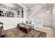 Bright living room with view to upstairs, featuring a gray sofa and area rug at 3578 Tranquility Trl, Castle Rock, CO 80109