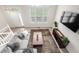 Open-concept living room featuring large windows, a comfortable sofa, and stylish decor at 3578 Tranquility Trl, Castle Rock, CO 80109