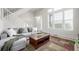 Bright living room with large window and a comfortable gray sofa and area rug at 3578 Tranquility Trl, Castle Rock, CO 80109
