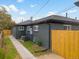 The rear exterior of the home shows meticulous brickwork, fresh landscaping, and a fenced yard at 3379 Krameria St, Denver, CO 80207
