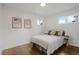 A cozy bedroom with hardwood floors offers a peaceful and relaxing retreat, complemented by natural light at 3379 Krameria St, Denver, CO 80207