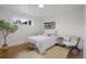 A sun-filled bedroom with hardwood floors is simply decorated to be the perfect tranquil retreat at 3379 Krameria St, Denver, CO 80207