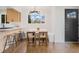 A dining area featuring modern lighting, bar stool seating, and an adjacent view of the kitchen at 3379 Krameria St, Denver, CO 80207