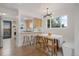 Bright and airy dining area featuring modern lighting, hardwood floors, and an adjacent view of the kitchen at 3379 Krameria St, Denver, CO 80207