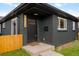 Charming brick home showcasing a black painted facade, modern address numbers, and inviting front entrance at 3379 Krameria St, Denver, CO 80207
