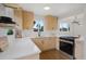 A modern kitchen features stainless steel appliances, light wood cabinetry, and a view of the outdoors at 3379 Krameria St, Denver, CO 80207