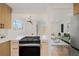 A kitchen flows into a living area, featuring modern appliances and finishes including a gas range at 3379 Krameria St, Denver, CO 80207
