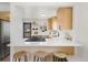 Modern kitchen with stainless steel appliances, quartz countertops, and three barstool seats at 3379 Krameria St, Denver, CO 80207