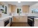 Well-lit kitchen featuring modern appliances, light wood cabinetry, and quartz countertops at 3379 Krameria St, Denver, CO 80207