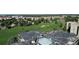 Expansive aerial view of the community with a golf course, buildings, and lush greenery under a sunny sky at 13952 E Marina Dr # 509, Aurora, CO 80014