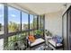 Relaxing balcony with seating and glass windows providing ample light and an outdoor view at 13952 E Marina Dr # 509, Aurora, CO 80014