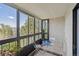 Cozy balcony area with small seating and glass windows for natural light and an outdoor view at 13952 E Marina Dr # 509, Aurora, CO 80014