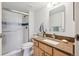Bathroom featuring a glass shower door, granite countertop, and modern fixtures at 13952 E Marina Dr # 509, Aurora, CO 80014