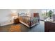 Cozy bedroom with a patterned quilt, side tables, and a bright window view at 13952 E Marina Dr # 509, Aurora, CO 80014