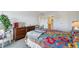 Comfortable bedroom featuring a colorful quilt, dresser, and lots of natural light at 13952 E Marina Dr # 509, Aurora, CO 80014