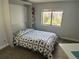 Bedroom with built-in Murphy bed, window view, and cozy decor at 13952 E Marina Dr # 509, Aurora, CO 80014