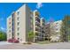 Spacious exterior view of the apartment building showing balconies and landscaping under a clear blue sky at 13952 E Marina Dr # 509, Aurora, CO 80014