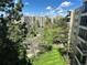 Exterior of a building surrounded by mature trees and a well-maintained lawn at 13952 E Marina Dr # 509, Aurora, CO 80014