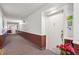 Well-lit hallway leading to individual units with decorative wall accents and patterned carpeting at 13952 E Marina Dr # 509, Aurora, CO 80014