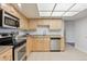 Well-lit kitchen featuring stainless steel appliances, light wood cabinetry, and granite countertops at 13952 E Marina Dr # 509, Aurora, CO 80014