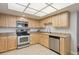 Kitchen view featuring stainless steel appliances, bright lighting and sleek countertops at 13952 E Marina Dr # 509, Aurora, CO 80014