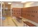Well-appointed locker room with wooden lockers, benches, and tile flooring at 13952 E Marina Dr # 509, Aurora, CO 80014