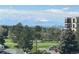 Scenic view with trees, golf course, and distant mountain range at 13952 E Marina Dr # 509, Aurora, CO 80014