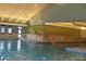 Large indoor swimming pool with natural light and safety equipment available at 13952 E Marina Dr # 509, Aurora, CO 80014