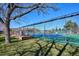 Outdoor tennis court featuring green and blue surface, surrounded by fencing and green space for recreational enjoyment at 13952 E Marina Dr # 509, Aurora, CO 80014