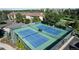 Aerial view of well-maintained tennis courts surrounded by greenery and community buildings at 13952 E Marina Dr # 509, Aurora, CO 80014