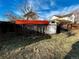 Fenced yard featuring a chicken coop, shed and space for outdoor activities under a bright sky at 9135 W Maplewood Ave, Littleton, CO 80123