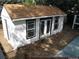 Back view of a white outbuilding with brown trim and a door and windows at 9135 W Maplewood Ave, Littleton, CO 80123