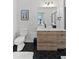 Bathroom with white toilet, hex floor tile, and light wood vanity at 3553 W 63Rd Ave, Denver, CO 80221